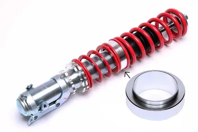 Intermediate spring plate for height adjustment