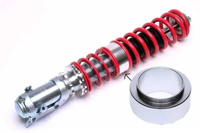 Intermediate spring plate for height adjustment